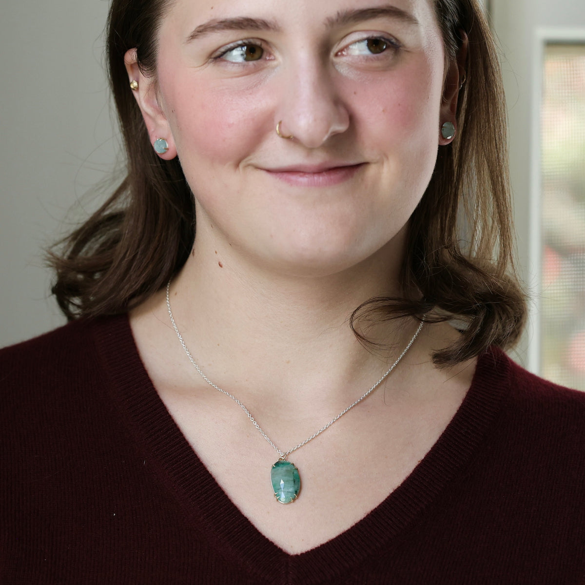 Woman wearing green stone necklace