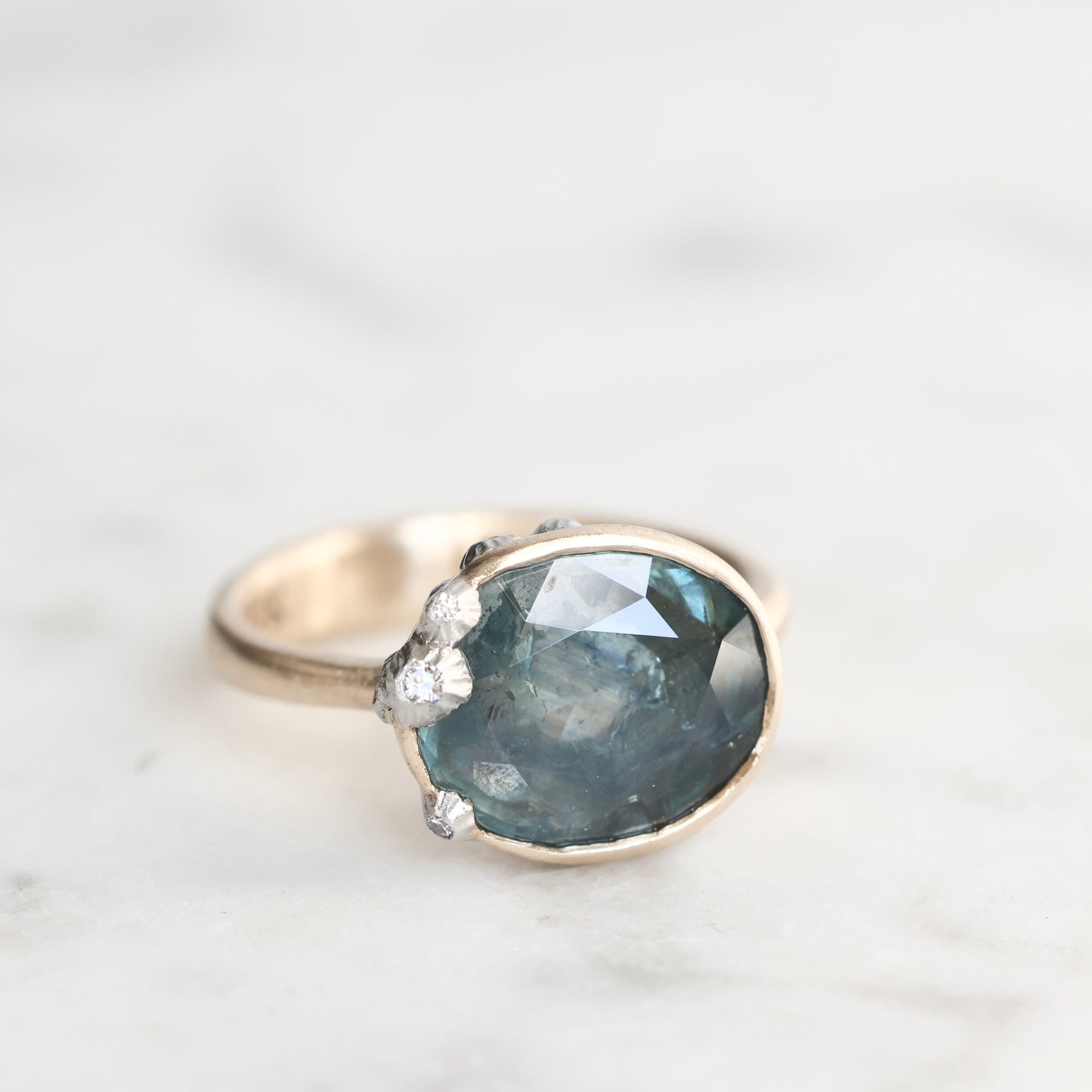 Ring with a large blue gemstone on a light background