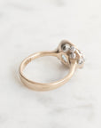 Gold ring with a diamond on a light gray background