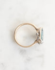 Silver ring with a gemstone on a marble surface