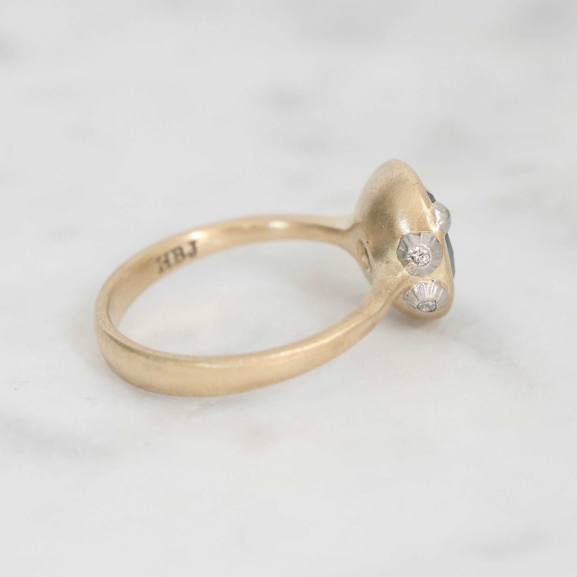 Gold ring with a diamond on a white background