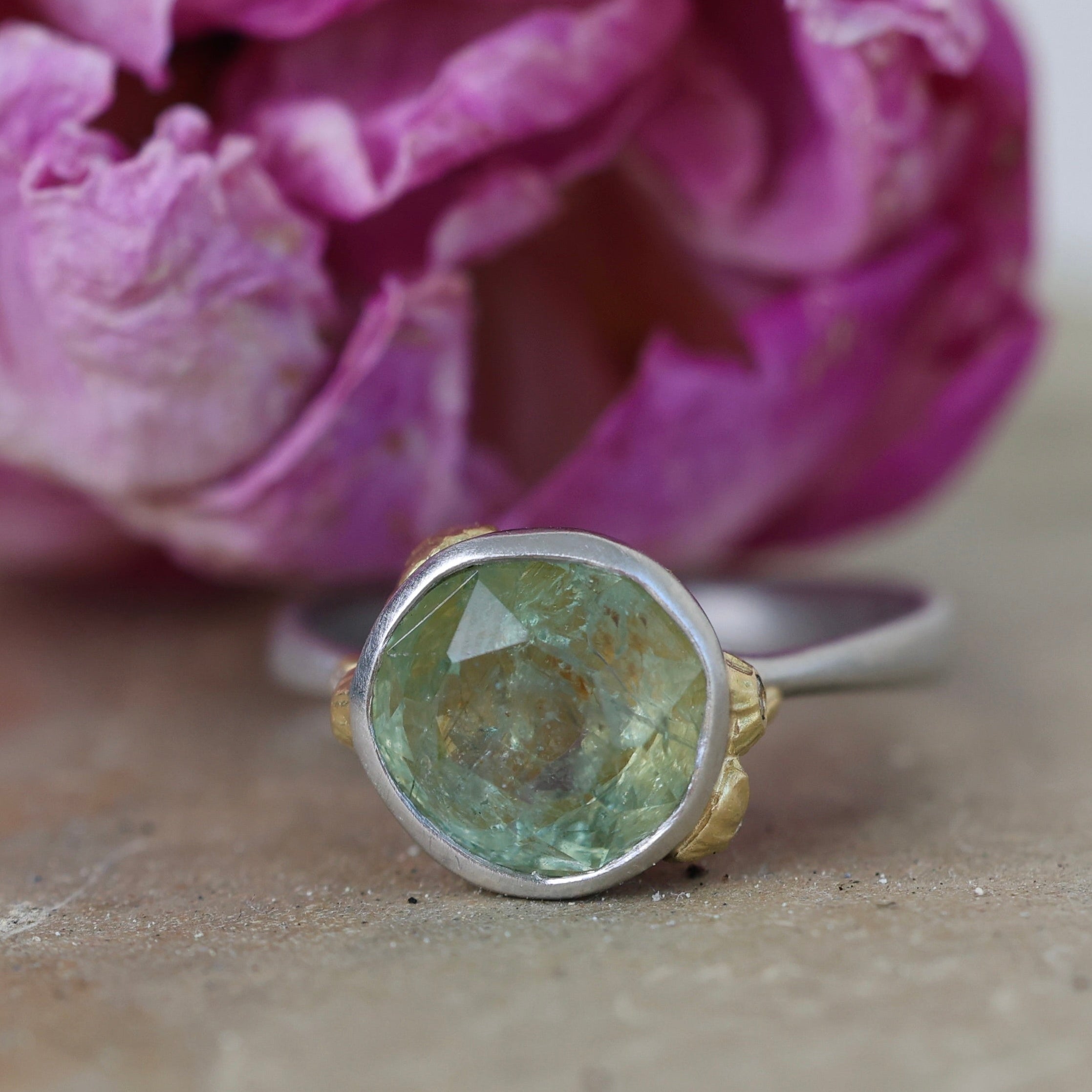 Ring with green Montana sapphire on a pink flower