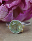 Ring with green Montana sapphire on a pink flower