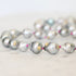 Pearl necklace with gold accents on a light background