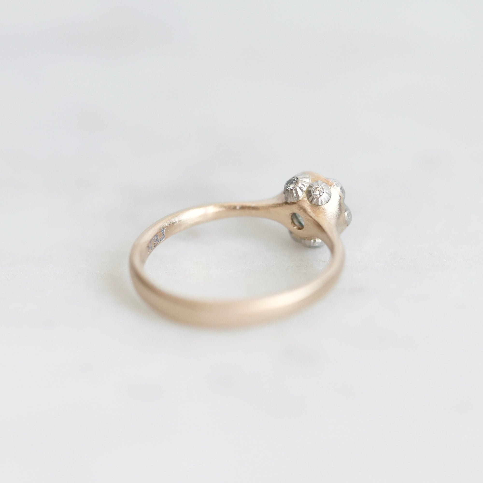 Back of Ruthie B. Ring. 14k yellow gold bezel with platinum barnacles set with tiny diamonds