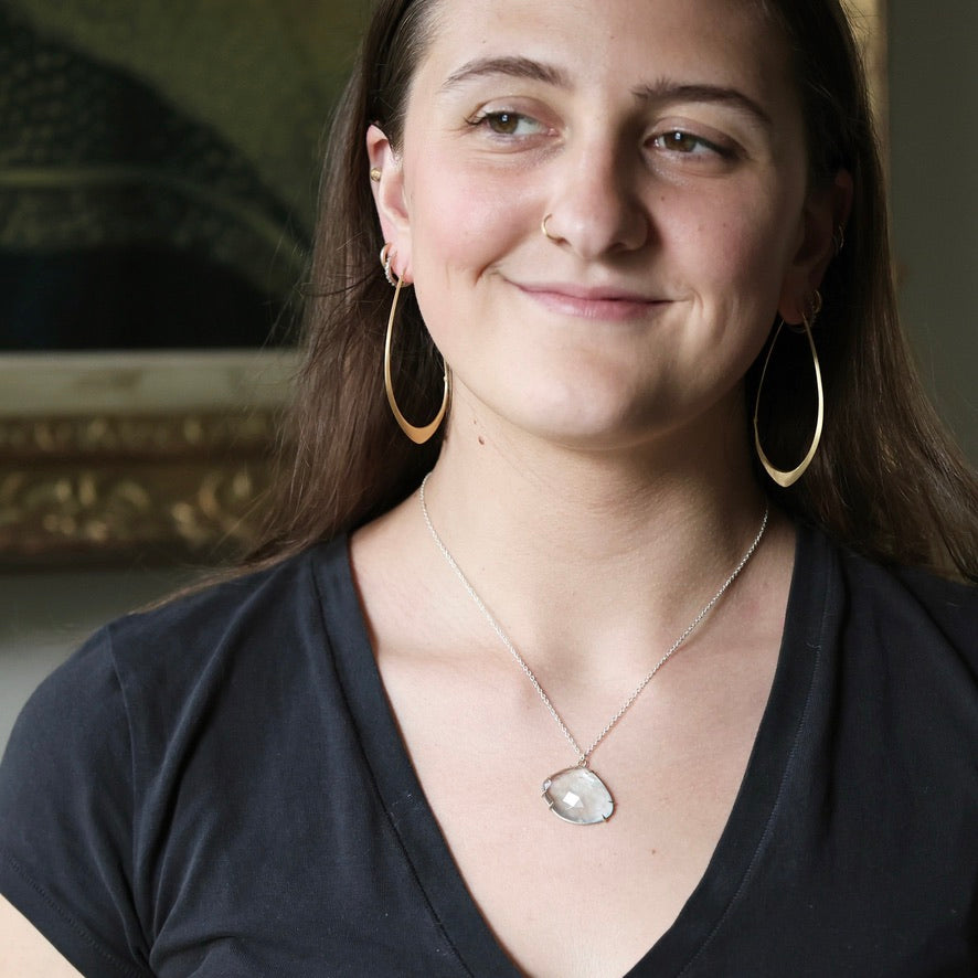 Woman wearing blue topaz necklace