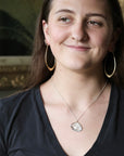 Woman wearing blue topaz necklace