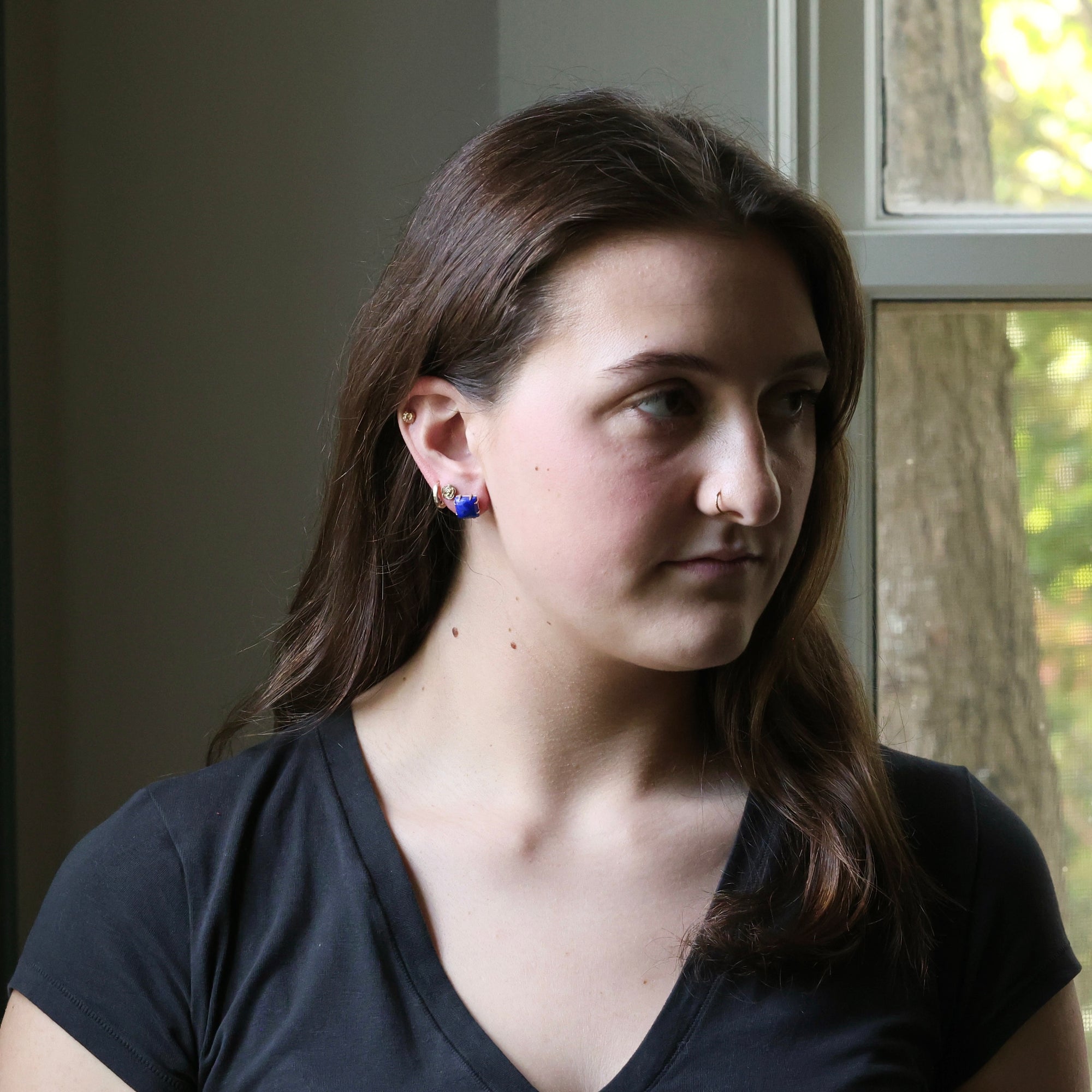 Woman wearing a black shirt with a neutral background