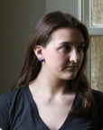 Woman wearing a black shirt with a neutral background