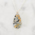Necklace with a teardrop-shaped pendant on a light gray background