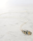 Necklace with a pendant on a white marble surface