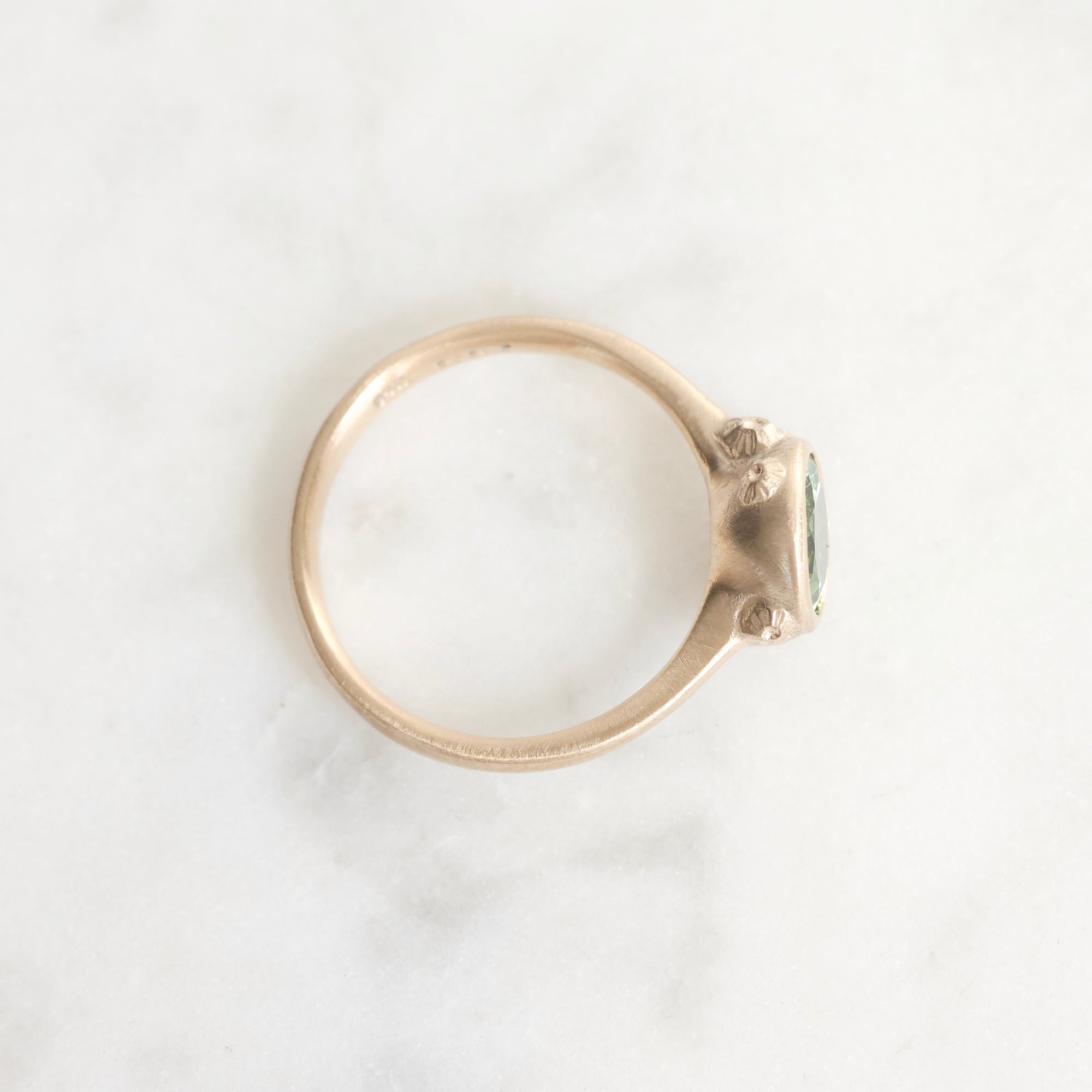 Gold ring with a gemstone on a white background
