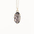 Necklace with a pendant featuring a gray stone and gold accents on a white background
