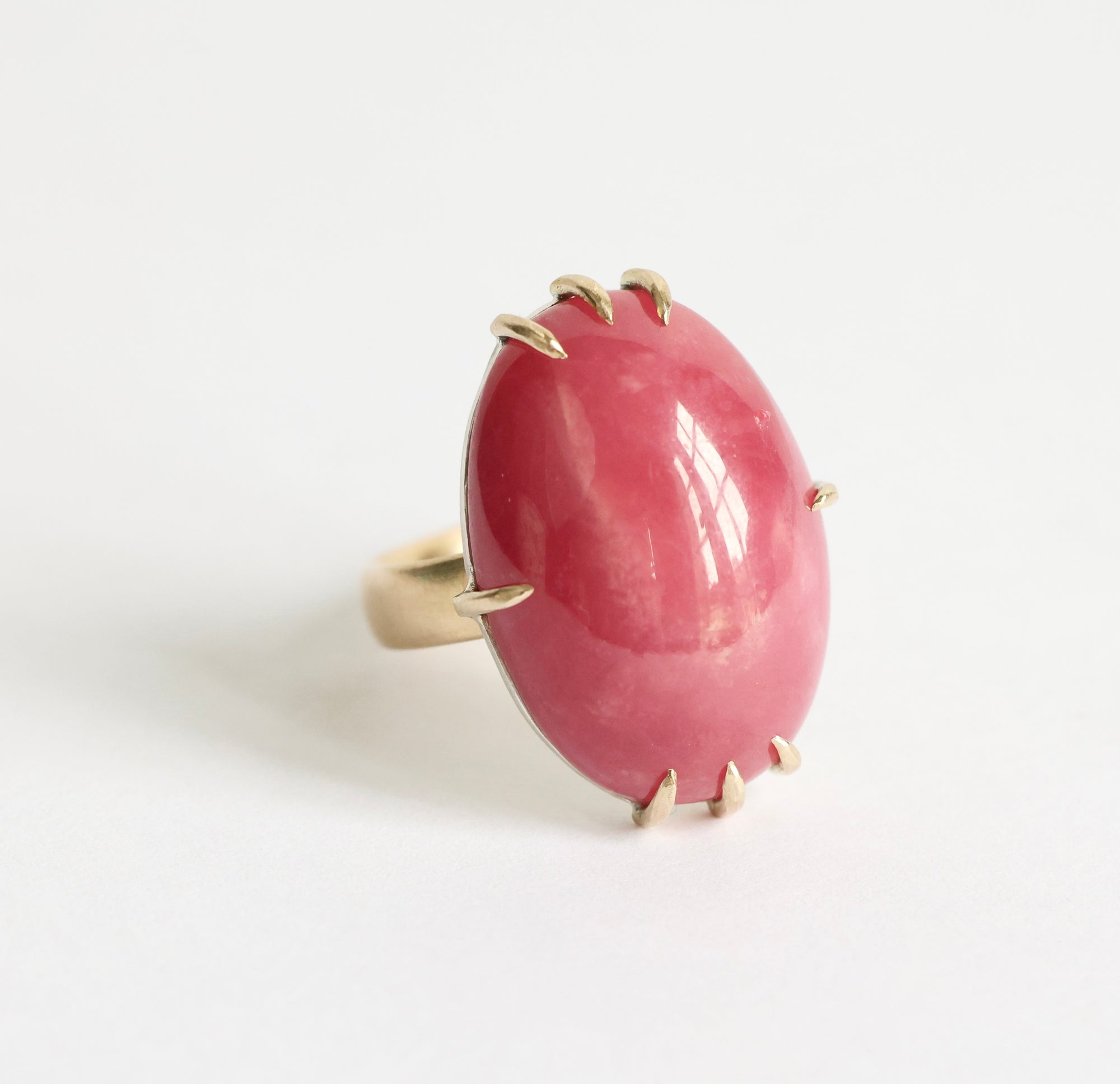 Pink ring with gold accents on a white background