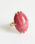 Pink ring with gold accents on a white background