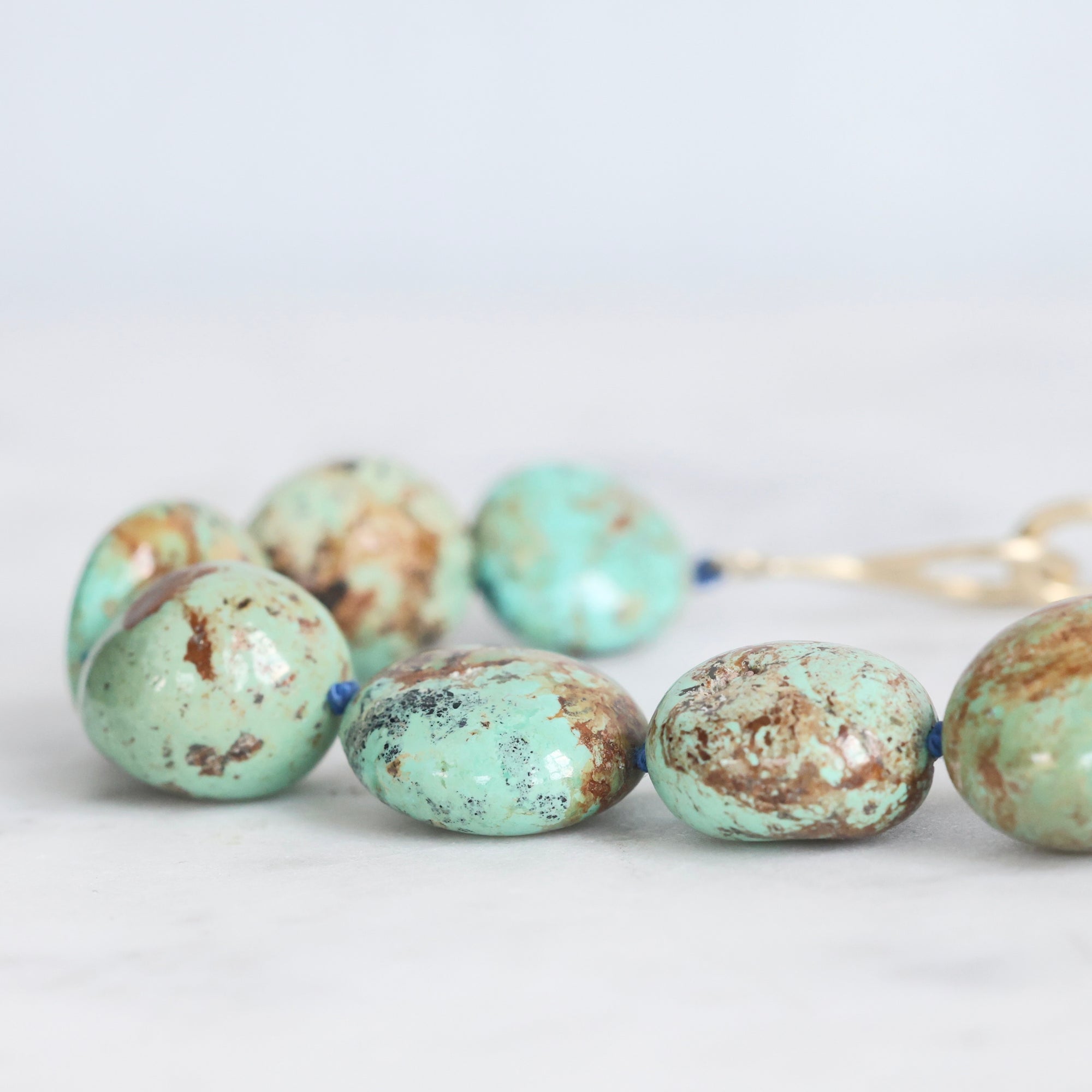 Turquoise beads on a white background