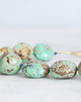 Turquoise beads on a white background