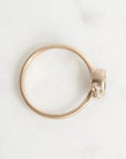 Gold ring with a unique design on a white background