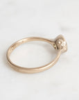 Gold ring with a small decorative element on a white background