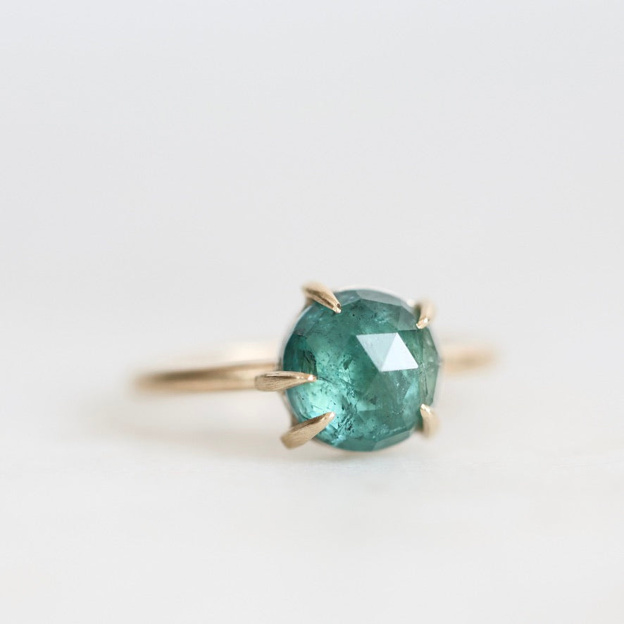 Green stone ring with prongs