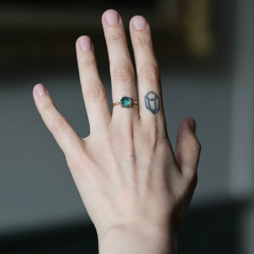 Hand wearing green stone ring 
