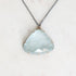 Blue topaz necklace with oxidized chain and setting. Gold prongs