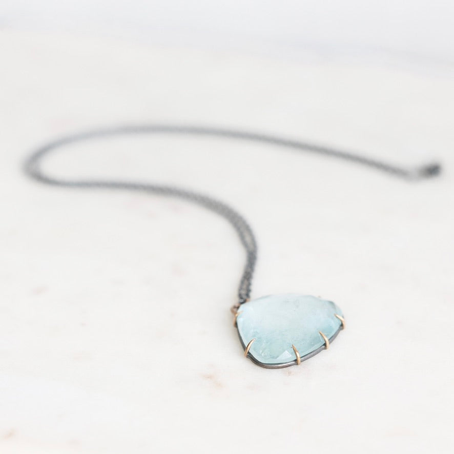 Blue topaz necklace on marble background