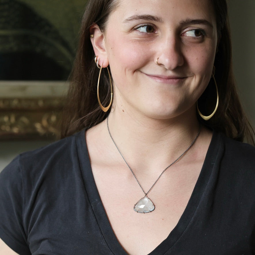 Woman wearing blue stone necklace with oxidized chain