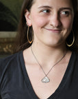 Woman wearing blue stone necklace with oxidized chain
