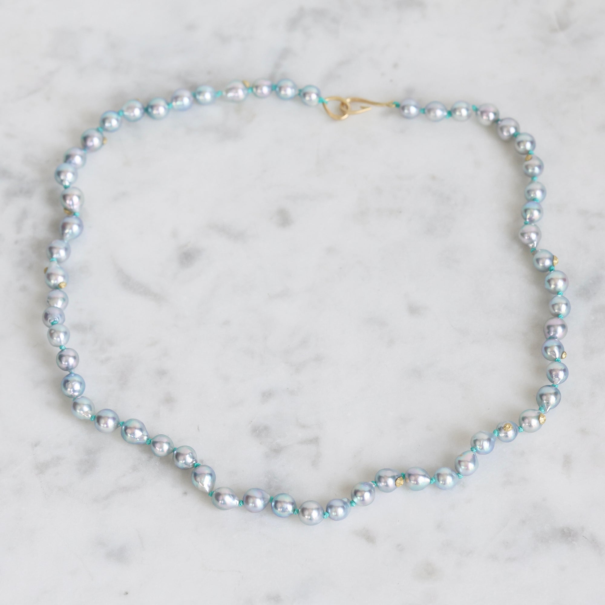 Pearl necklace on a marble surface