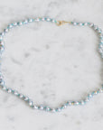 Pearl necklace on a marble surface