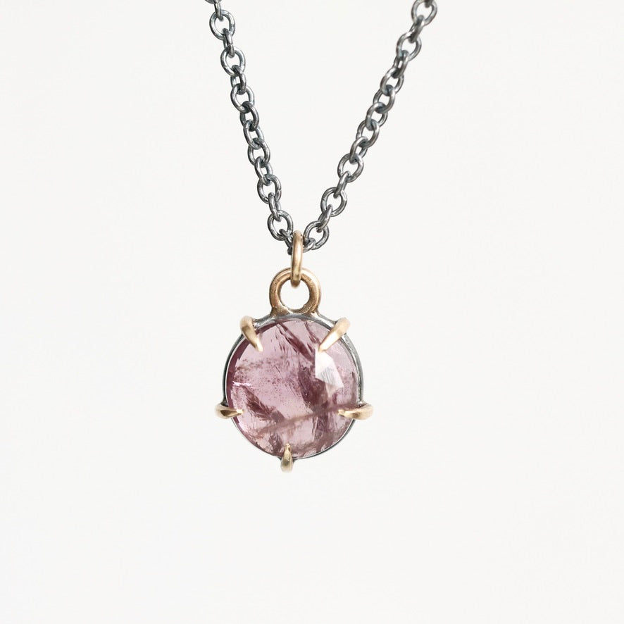 Purple spinel necklace held in gold prongs