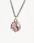 Purple spinel necklace held in gold prongs