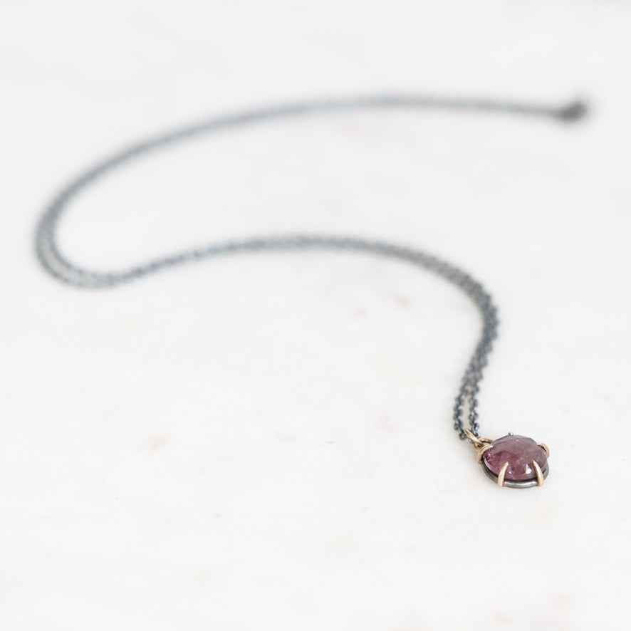 Purple spinel necklace on marble background