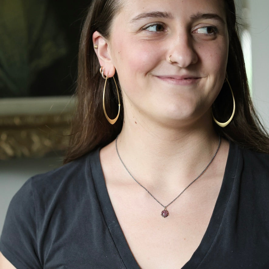 Woman wearing purple spinel necklace