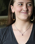 Woman wearing purple spinel necklace
