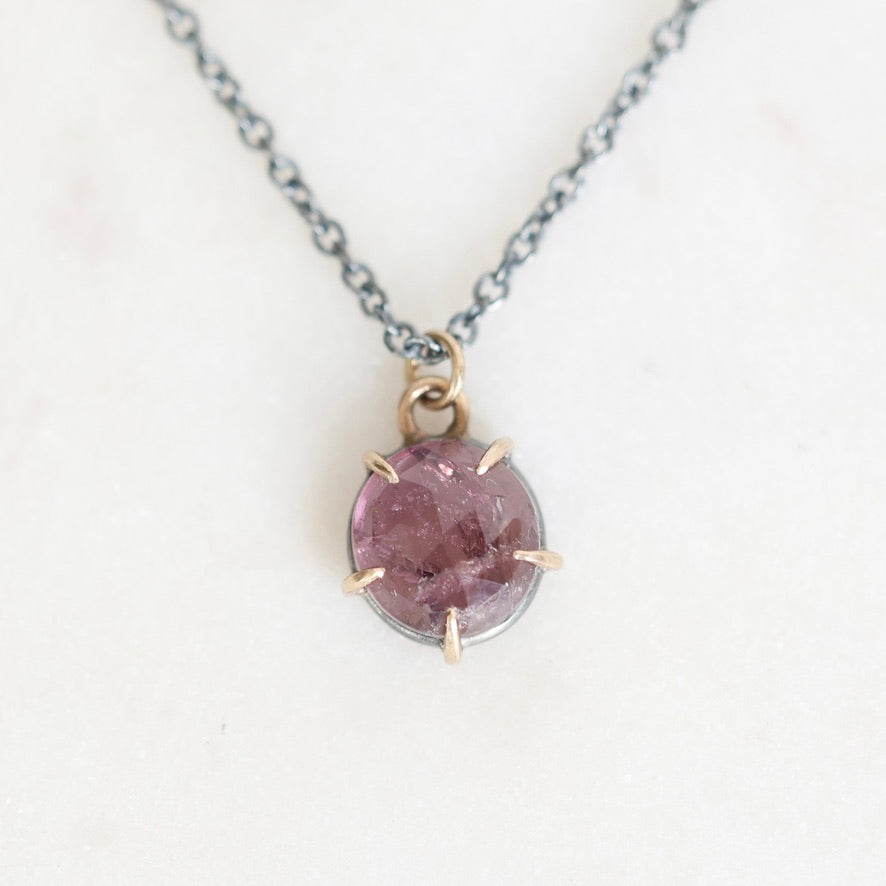 Purple spinel necklace on marble background