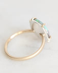 Back of ring with gold prongs and gold band. Backplate is silver. Against a white background. 