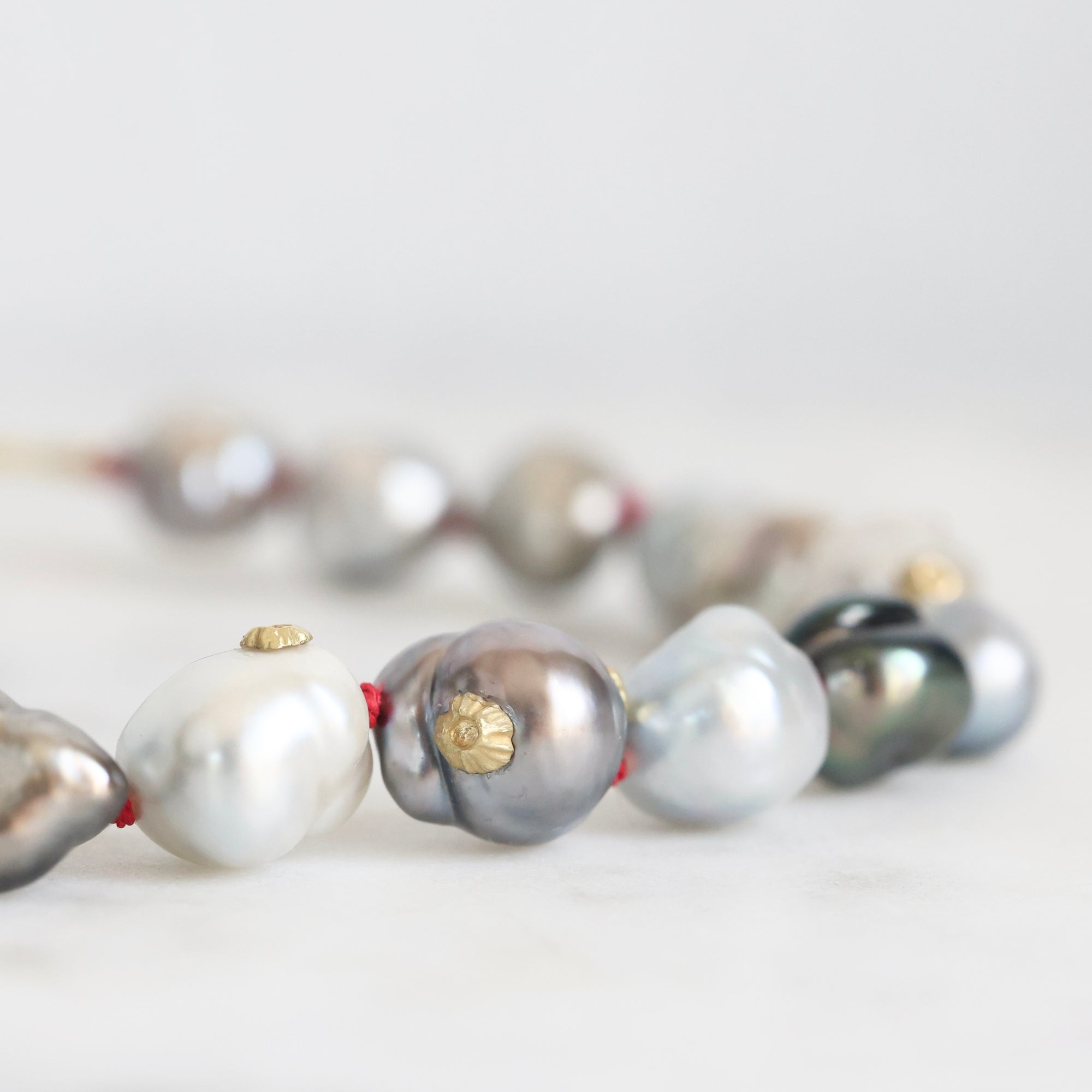 Necklace with pearls on a light background