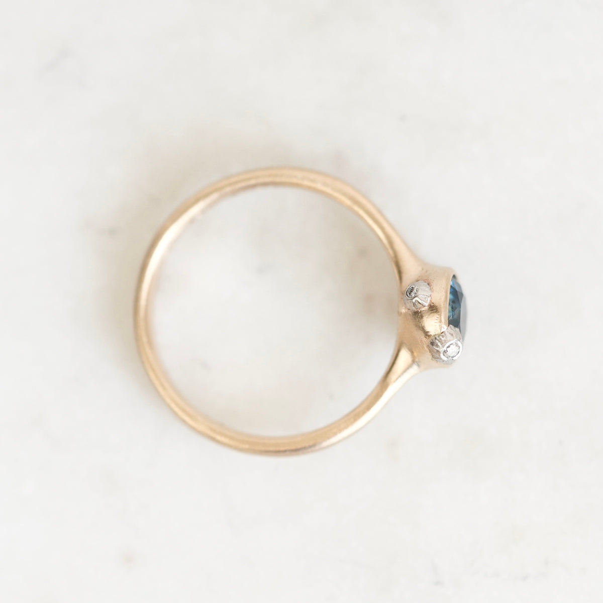 Ring from above with gold bezel setting and platinum barnacles. 