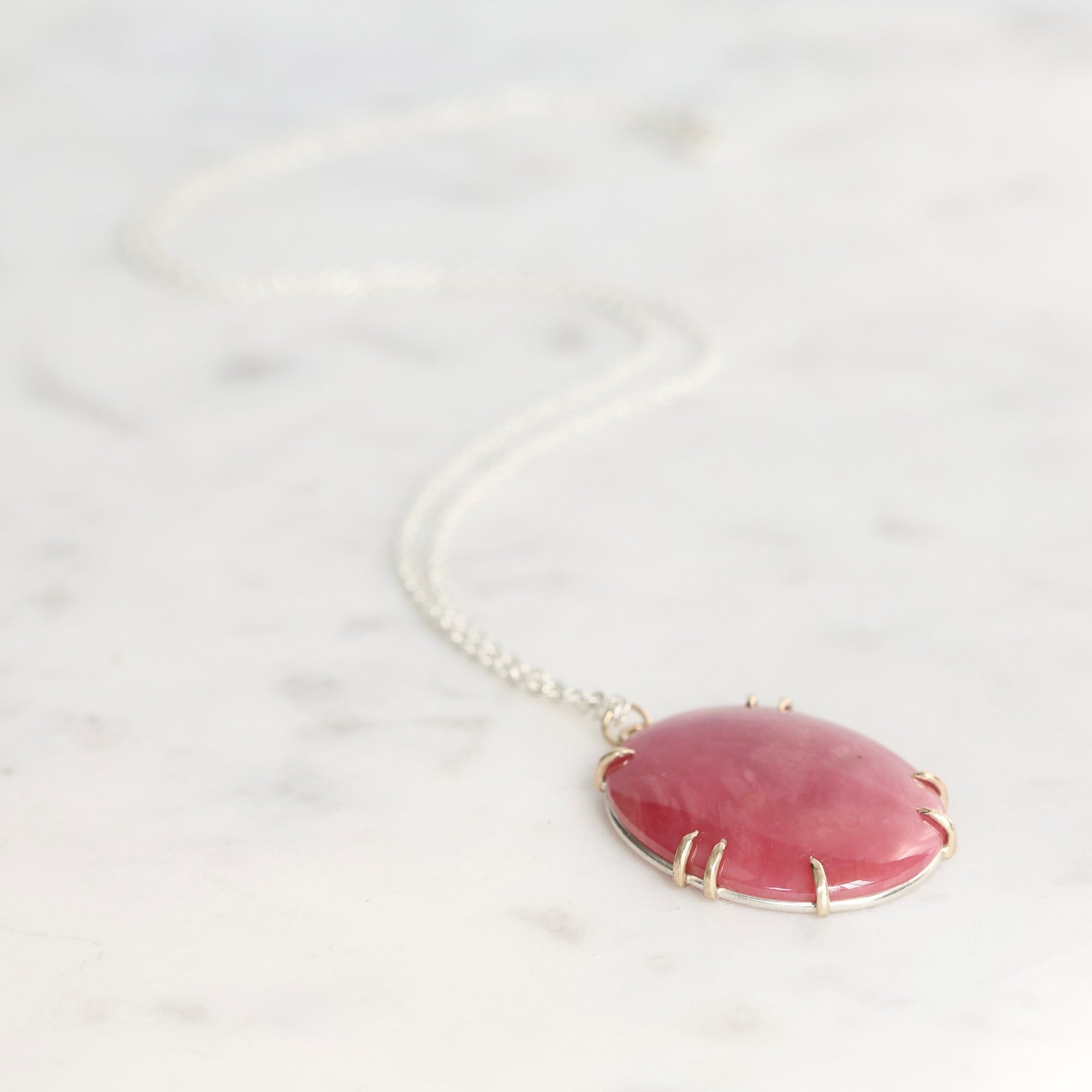 Necklace with a pink pendant on a white background
