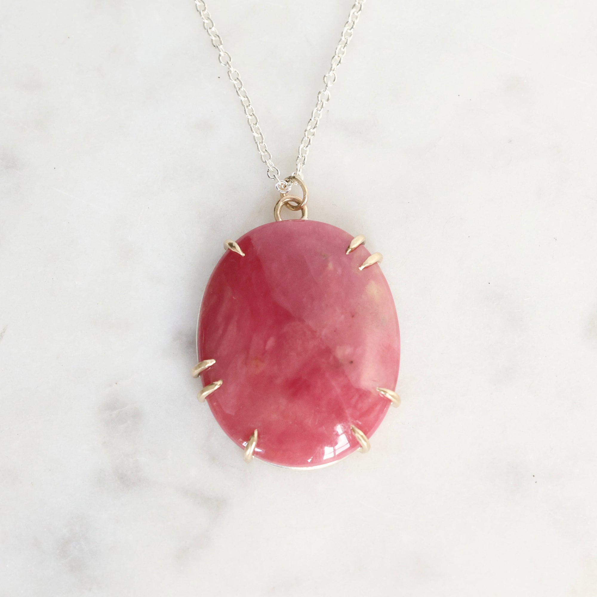 Pink stone pendant on a white background