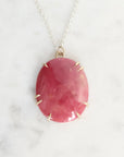 Pink stone pendant on a white background