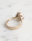 Silver ring with gemstones on a light gray background