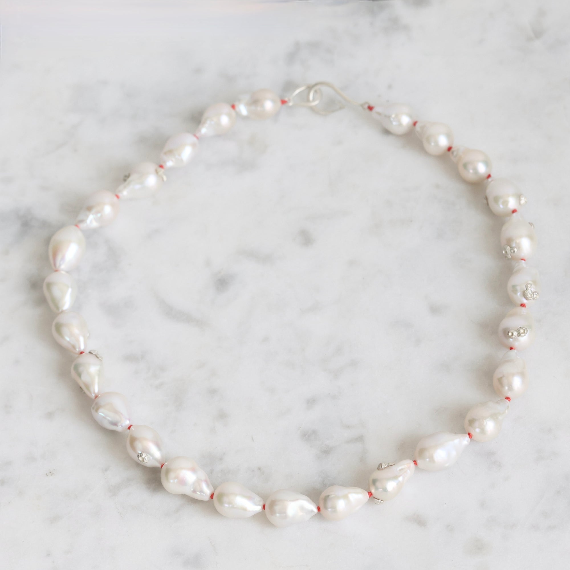 Pearl necklace on a marble surface