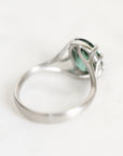 A silver ring with a green marquise-cut gemstone, photographed on a clean white background.