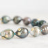 Pearl necklace with gold accents on a light background
