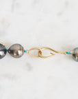 Pearl necklace with gold clasp on a white background