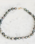 Gray pearl necklace on a marble surface