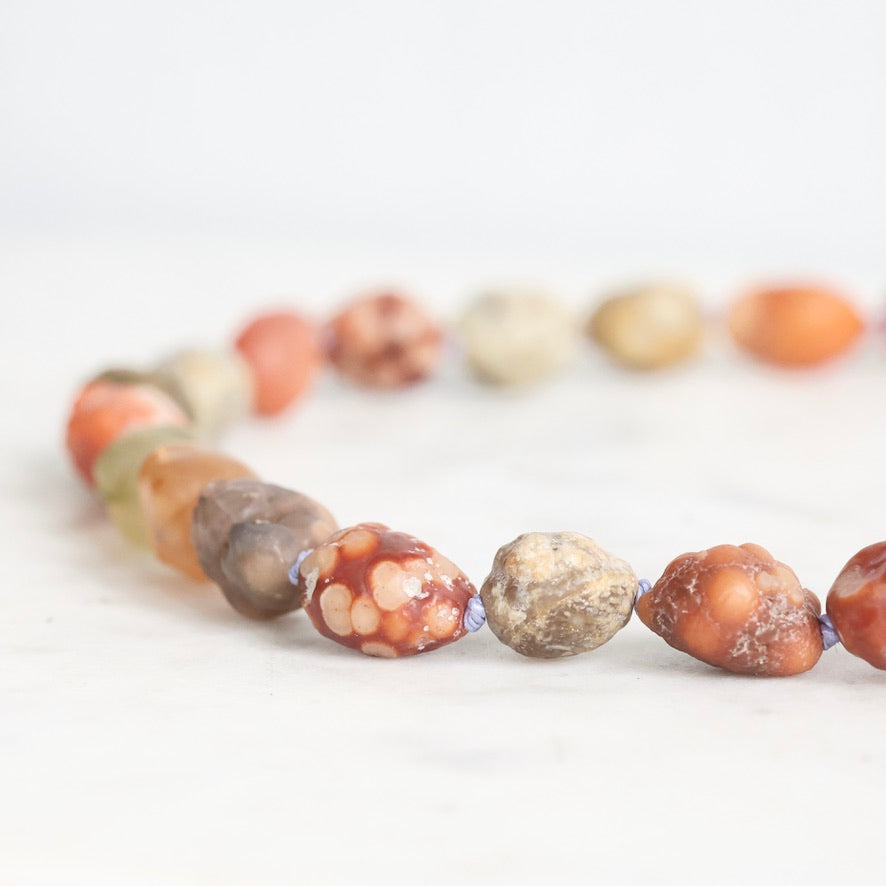 Necklace with multicolored beads on a white background
